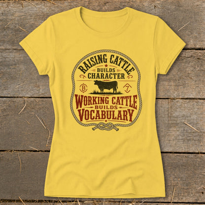 Yellow t-shirt with "Raising Cattle Builds Character" and "Working Cattle Builds Vocabulary" text and bull graphic.