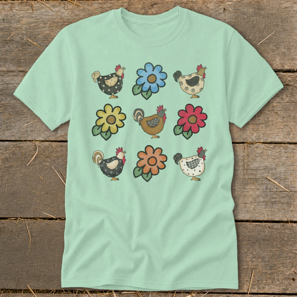 Light mint green t-shirt with a nine-panel print of chickens and flowers.