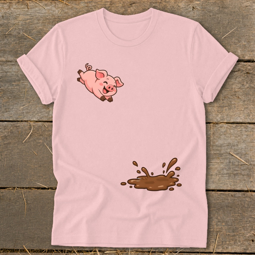 Pink t-shirt with cartoon pig jumping through a mud puddle.