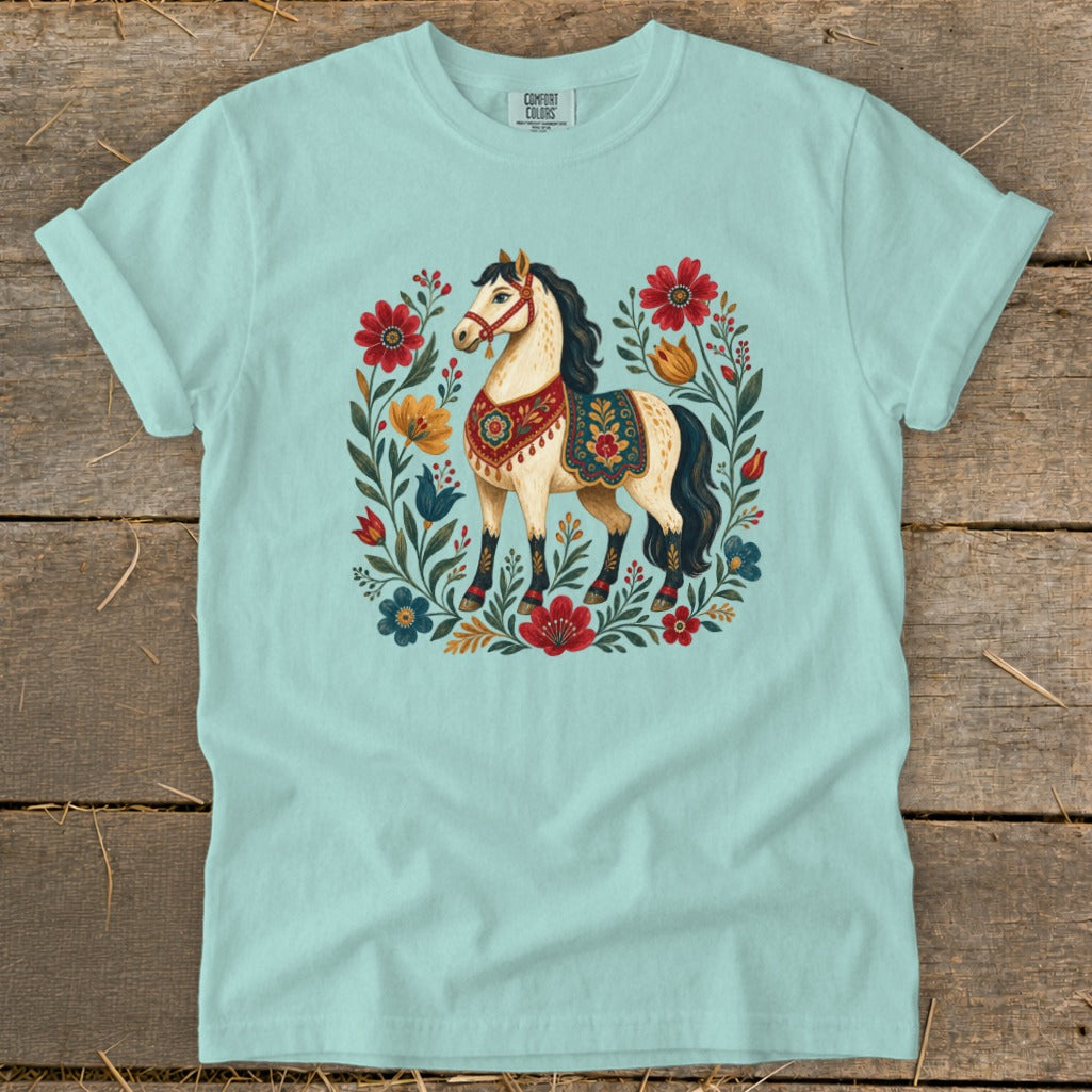 Light blue t-shirt with a cream horse surrounded by a floral wreath.