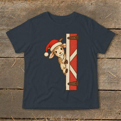 Goat wearing Santa hat peeking around a barn door graphic on a t-shirt.