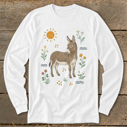 White long-sleeve shirt with a drawing of a donkey surrounded by flowers and sun.