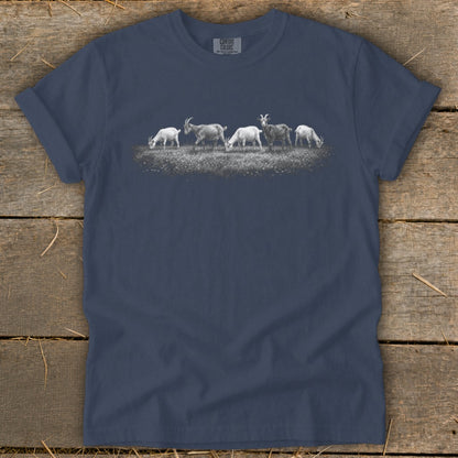 Navy t-shirt with a print of six goats grazing in a field.