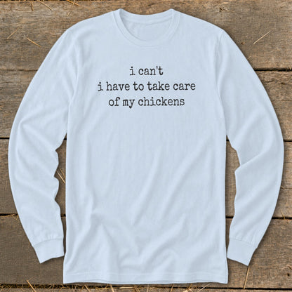 Light blue long-sleeve shirt with "i can't i have to take care of my chickens" text.