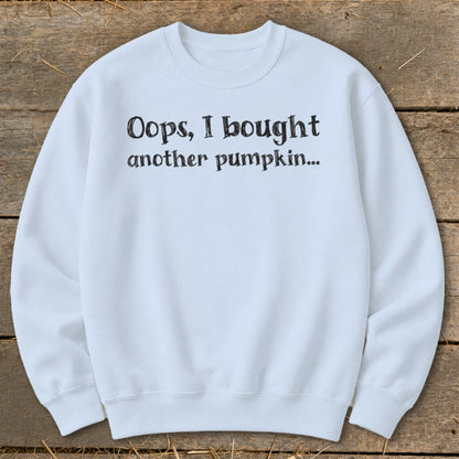 Light blue sweatshirt with black text "Oops, I bought another pumpkin..."