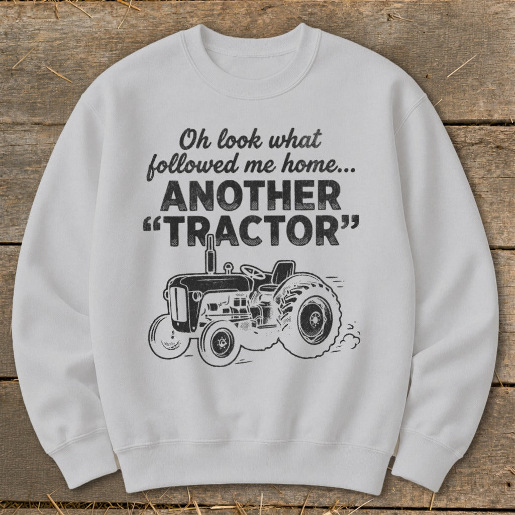 White sweatshirt with text and tractor graphic: "Oh look what followed me home... ANOTHER TRACTOR".