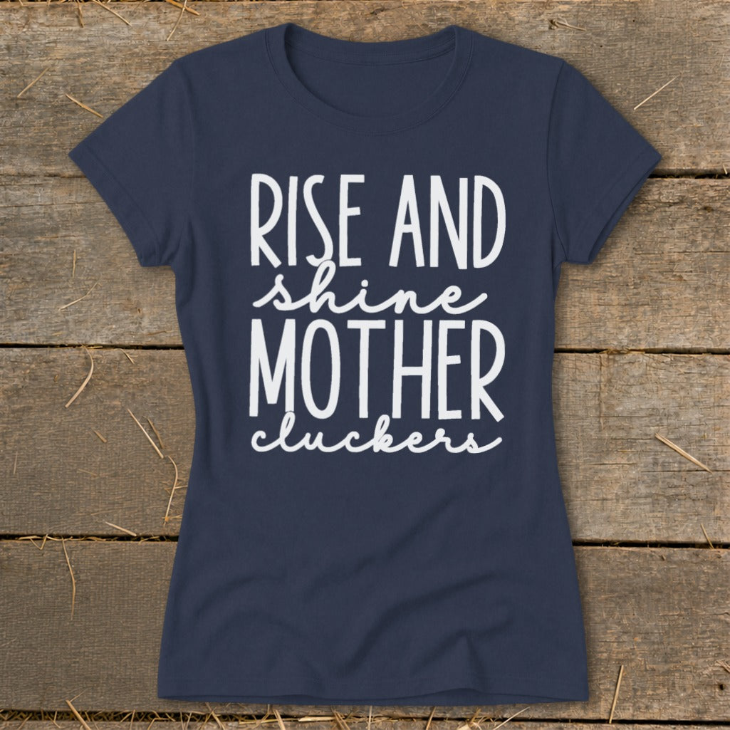 Navy t-shirt with white text that says "Rise and shine mother cluckers".