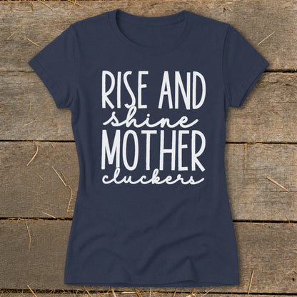 Navy t-shirt with white text that says "Rise and shine mother cluckers".