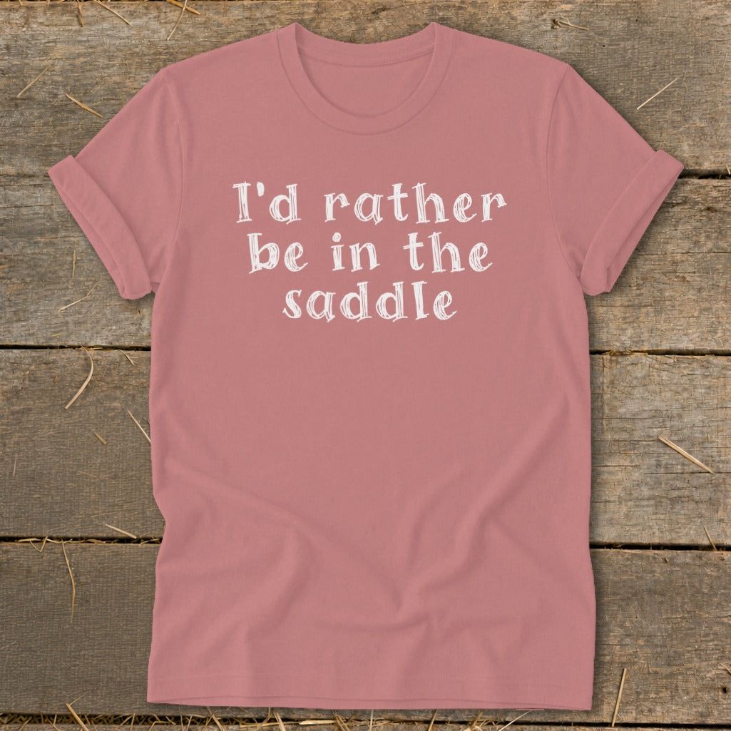 Pink t-shirt with white text "I'd rather be in the saddle."
