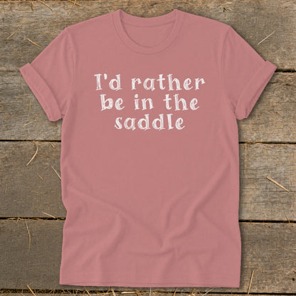 Pink t-shirt with white text "I'd rather be in the saddle."