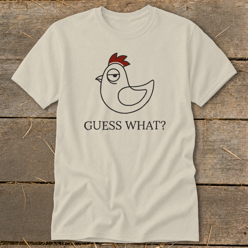 Cream t-shirt with a cartoon chicken graphic and "GUESS WHAT?" text.