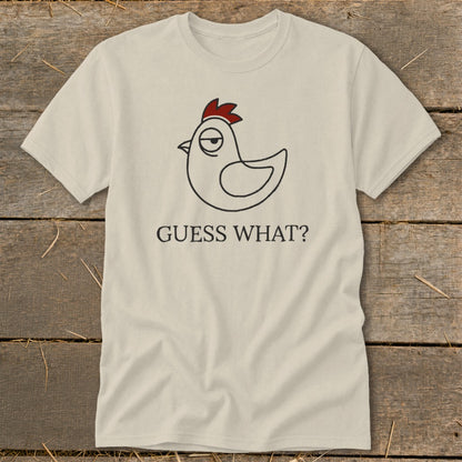 Cream t-shirt with a cartoon chicken graphic and "GUESS WHAT?" text.