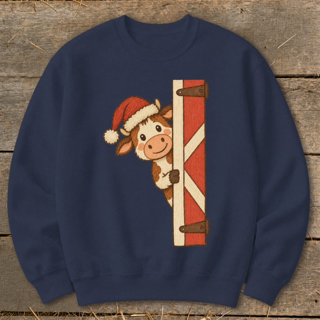 Navy sweatshirt with a cartoon cow wearing a Santa hat peeking from behind a barn door.