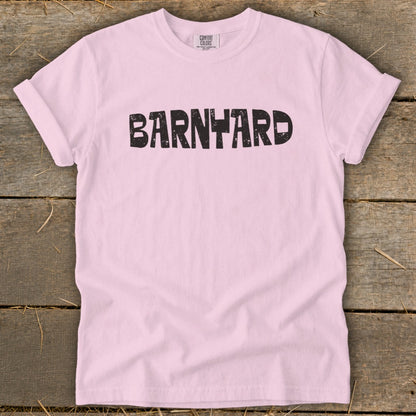 Light pink t-shirt featuring the word BARNYARD in distressed black block letters across the chest.