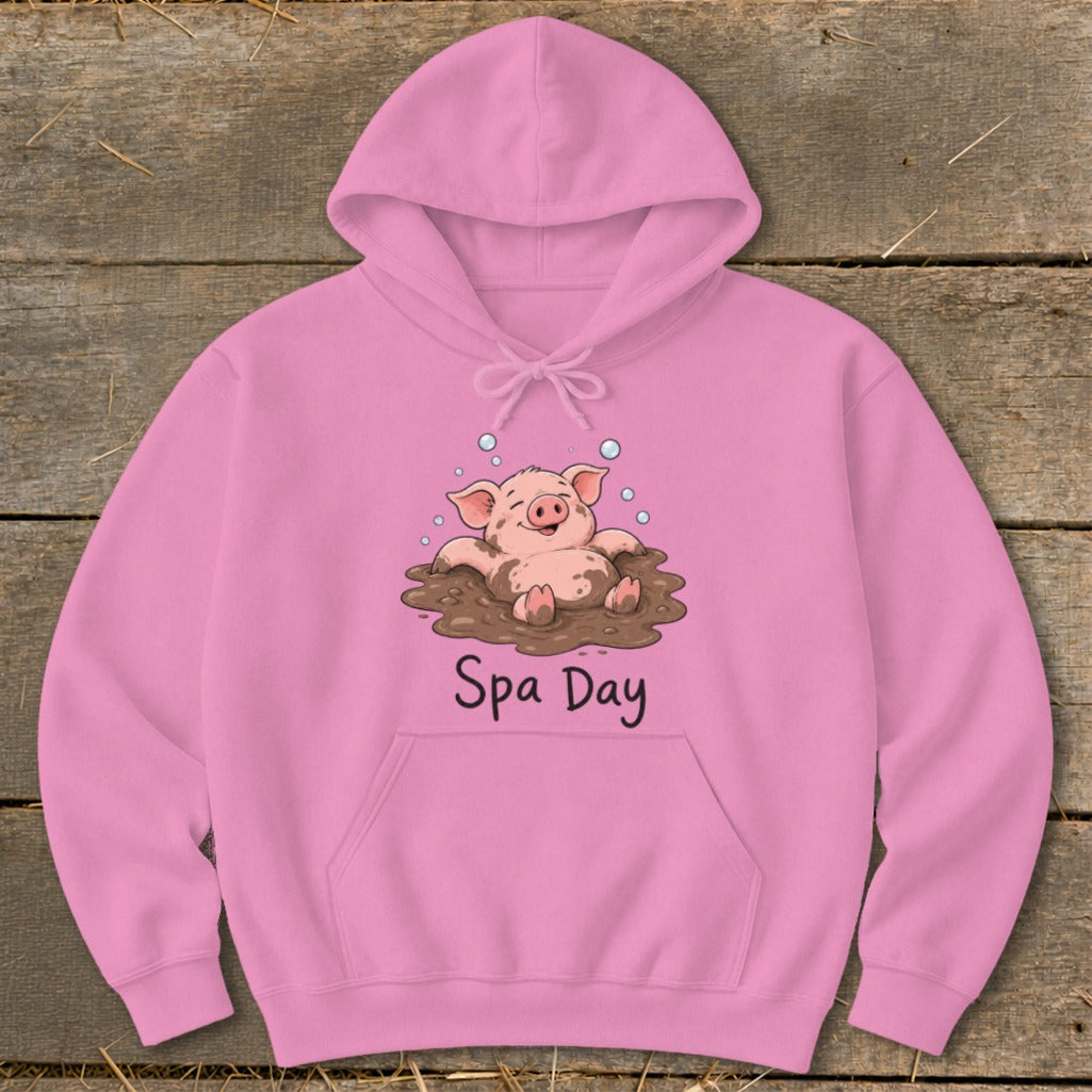 Pink hoodie with a cartoon pig in mud and text that says "Spa Day".