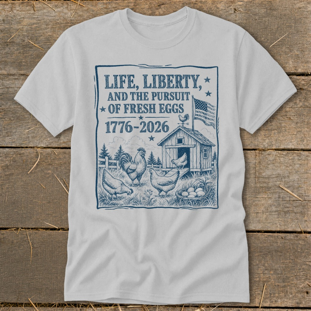 White t-shirt with graphic: "Life, Liberty, and the Pursuit of Fresh Eggs 1776-2026."