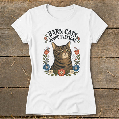 White t-shirt with a brown tabby cat surrounded by flowers and the text "Barn Cats Judge Everyone".