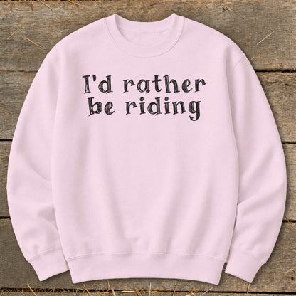 Pink crewneck sweatshirt with black text that reads "I'd rather be riding."