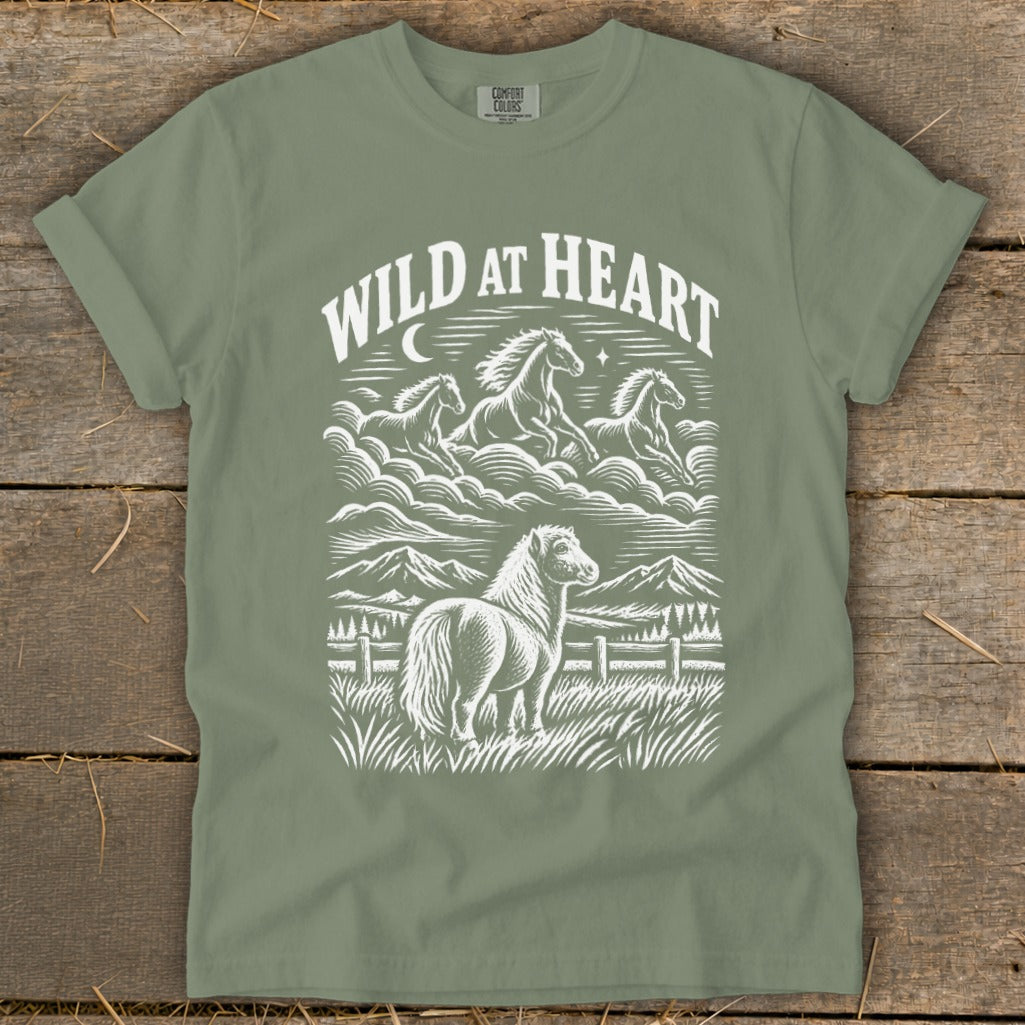 T-shirt with white graphic of horses and mountains, text reads "WILD AT HEART".
