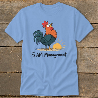 Light blue t-shirt with a cartoon rooster crowing at sunrise, text reads "5 AM Management".