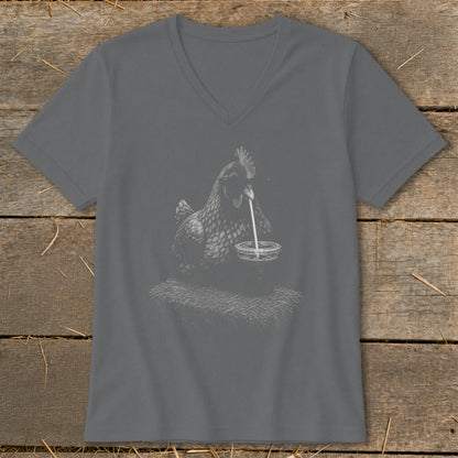 Chicken drinking from a cup with a straw, on a pile of hay graphic.
