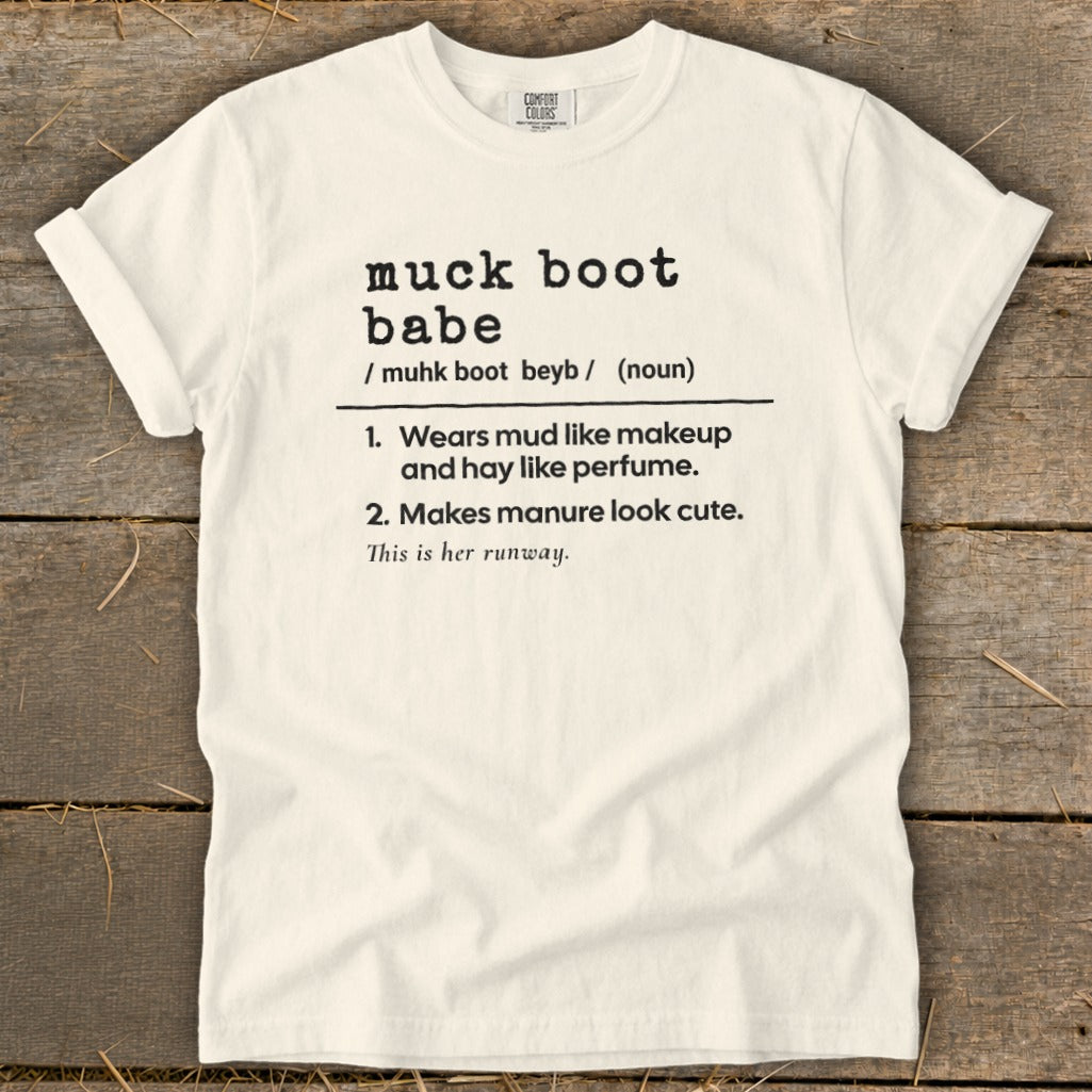 Cream t-shirt with black text defining "muck boot babe".