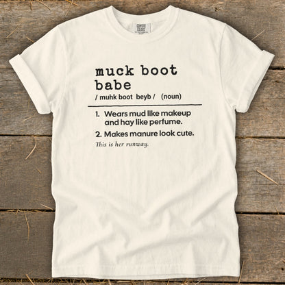 Cream t-shirt with black text defining "muck boot babe".