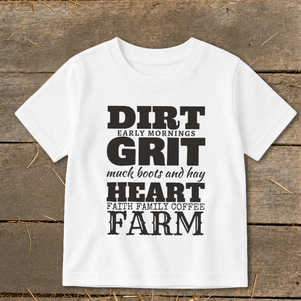 White t-shirt with black text reading "DIRT EARLY MORNINGS GRIT muck boots and hay HEART FAITH FAMILY COFFEE FARM"