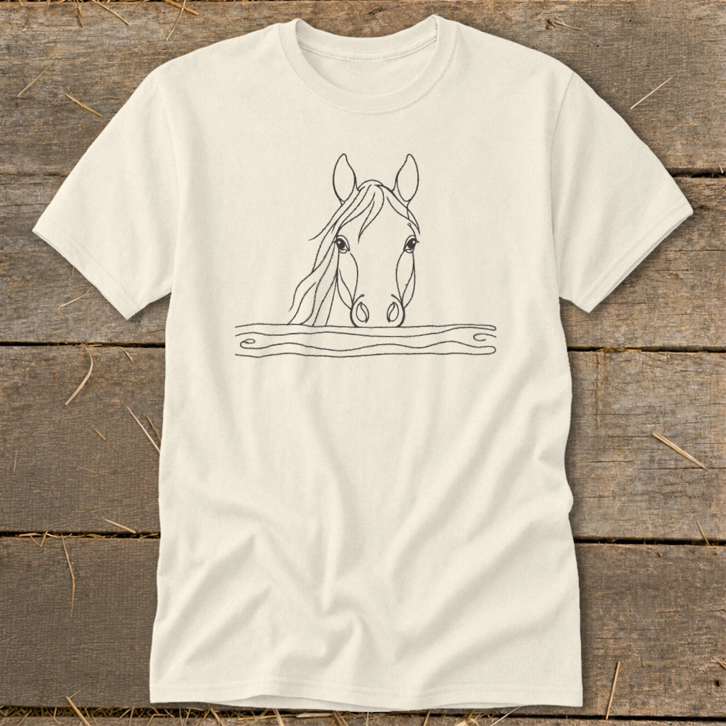 Cream t-shirt with a minimalist line drawing of a horse's head peeking over a fence.
