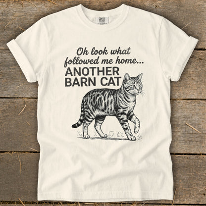 Cream t-shirt with text "Oh look what followed me home... ANOTHER BARN CAT" and a tabby cat illustration.