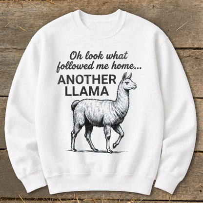 White sweatshirt with sketch of llama and text "Oh look what followed me home... ANOTHER LLAMA".