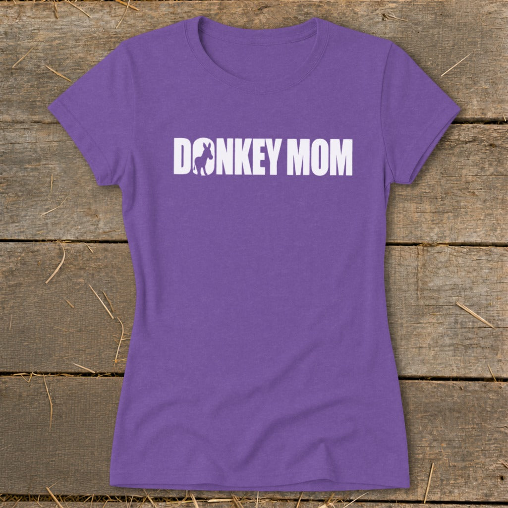 Purple women’s t-shirt featuring the white text DONKEY MOM with a donkey silhouette inside the letter O.