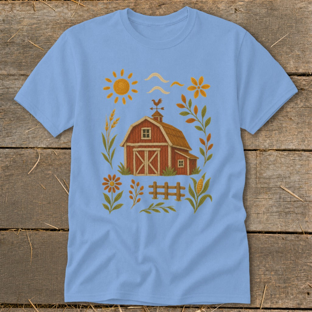 Light blue t-shirt with a red barn, sun, and farm-themed illustrations.