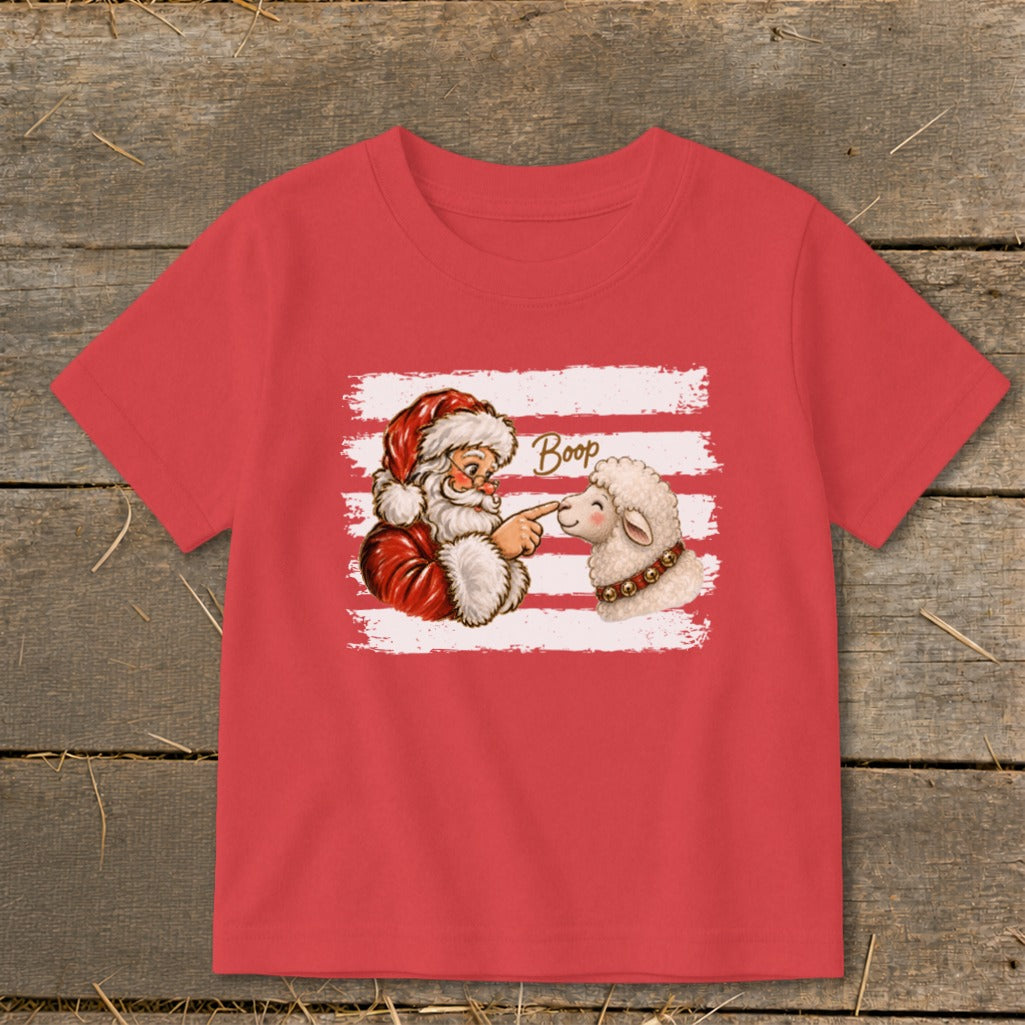Santa "booping" a sheep's nose with text on a red t-shirt.