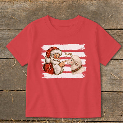 Santa "booping" a sheep's nose with text on a red t-shirt.