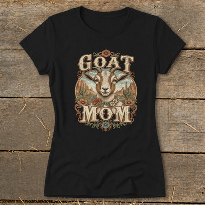 Black t-shirt with "GOAT MOM" text and goat illustration in desert landscape.
