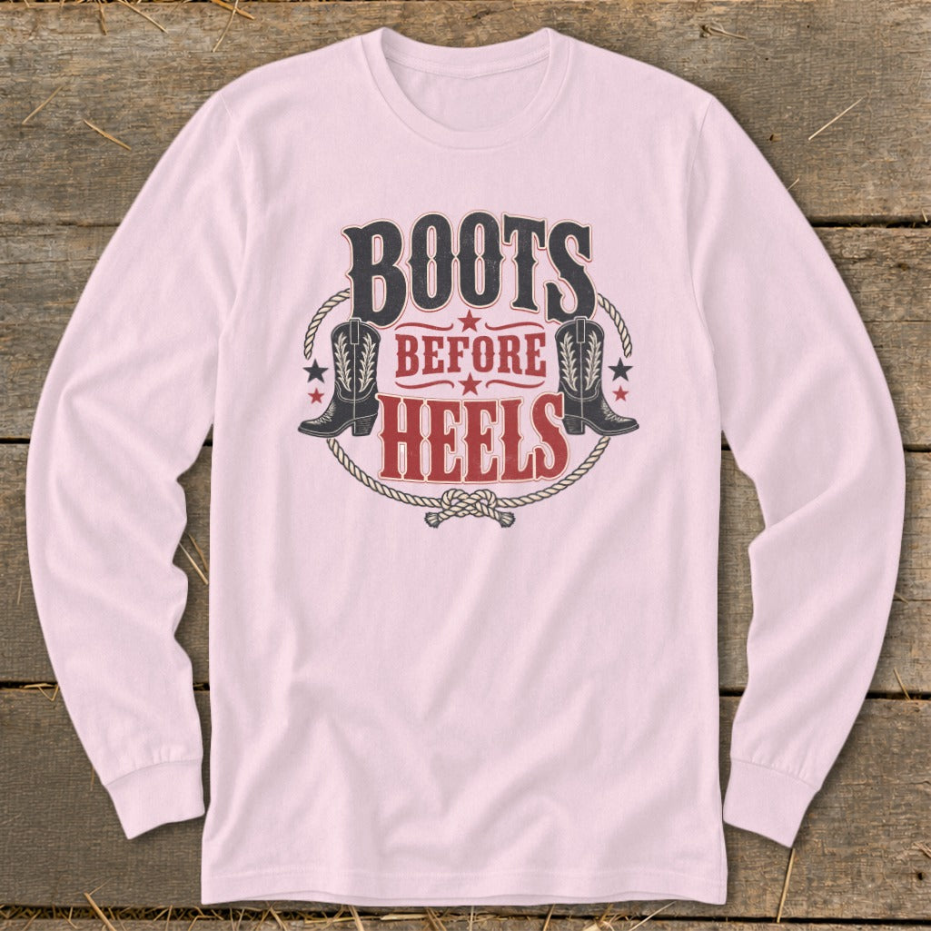 Pink long-sleeved shirt with "Boots Before Heels" graphic and cowboy boots.