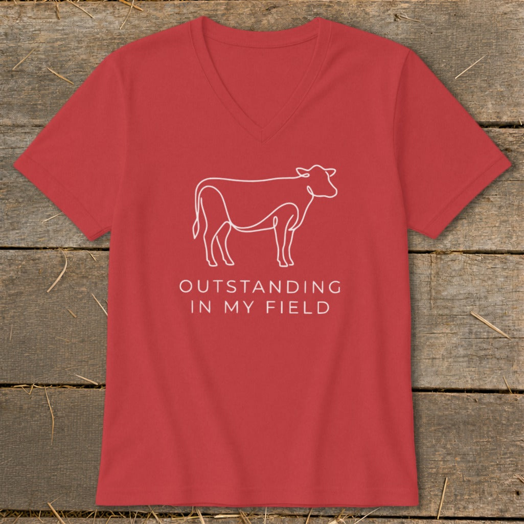 Red t-shirt with white cow outline and text "OUTSTANDING IN MY FIELD".