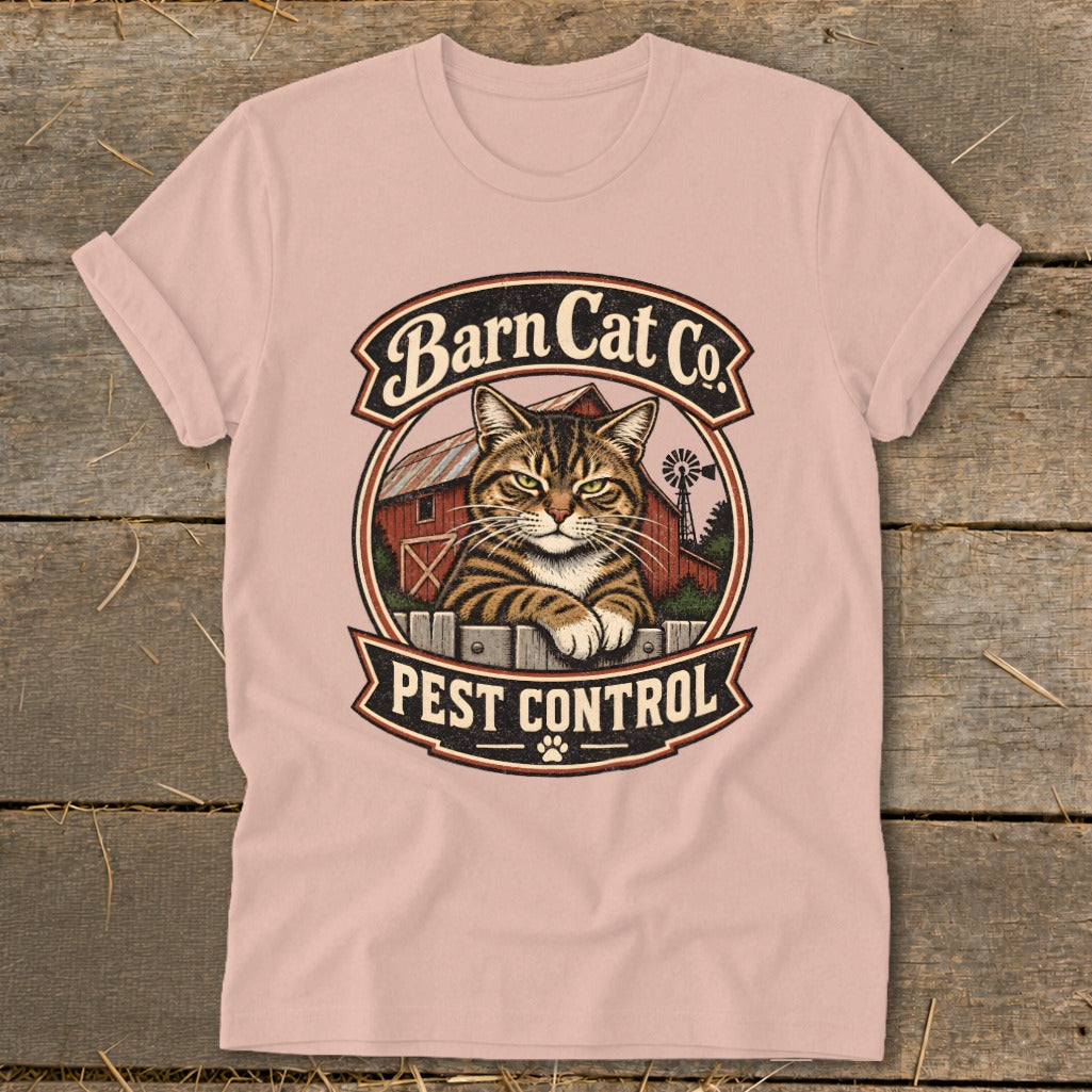 Pink crewneck t-shirt featuring a circular graphic of a tabby cat and text reading Barn Cat Co. Pest Control.