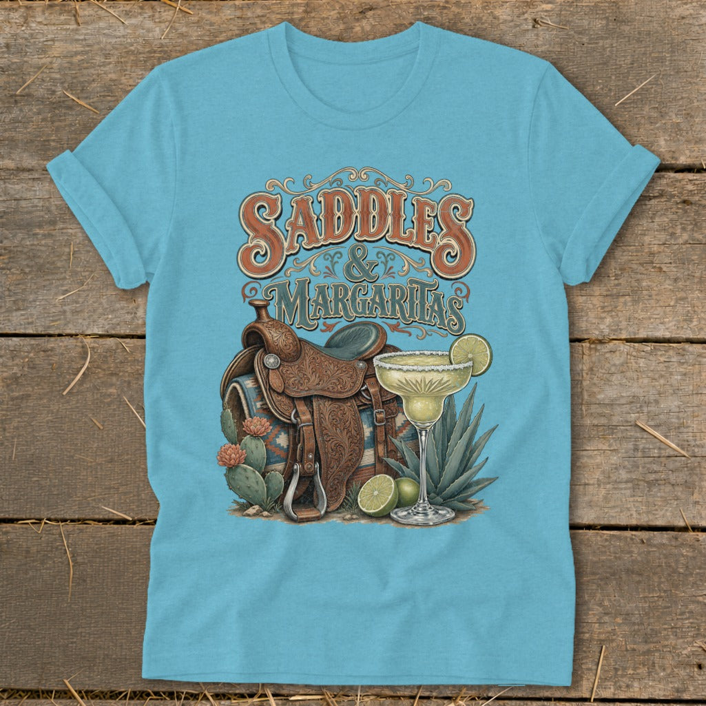 Light blue t-shirt graphic with saddles, margaritas, cacti, and desert plants.