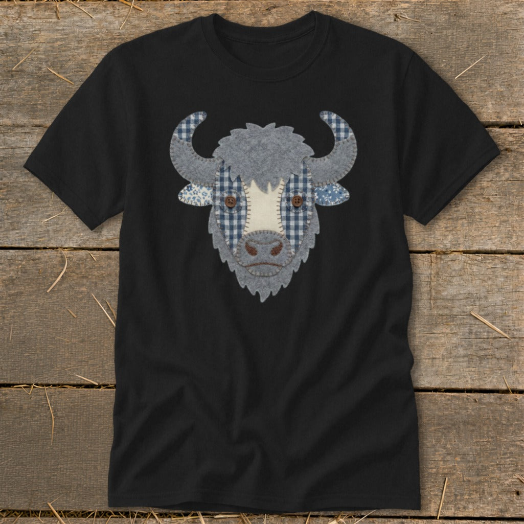 Black t-shirt with a fabric applique of a bull's face featuring blue gingham and brown buttons.