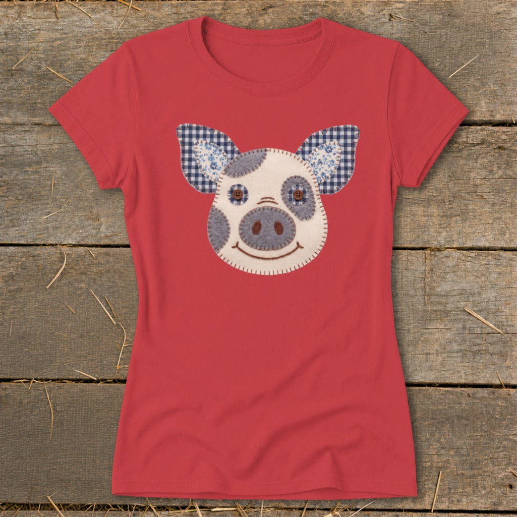 Red t-shirt with a patched pig face design on the chest.