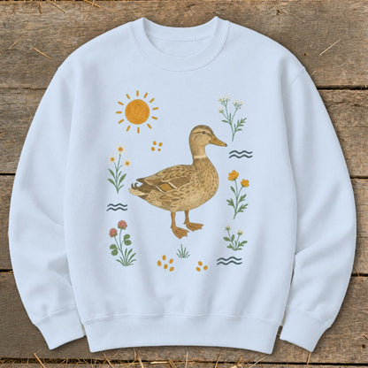 Light blue sweatshirt with a watercolor duck and floral illustration.