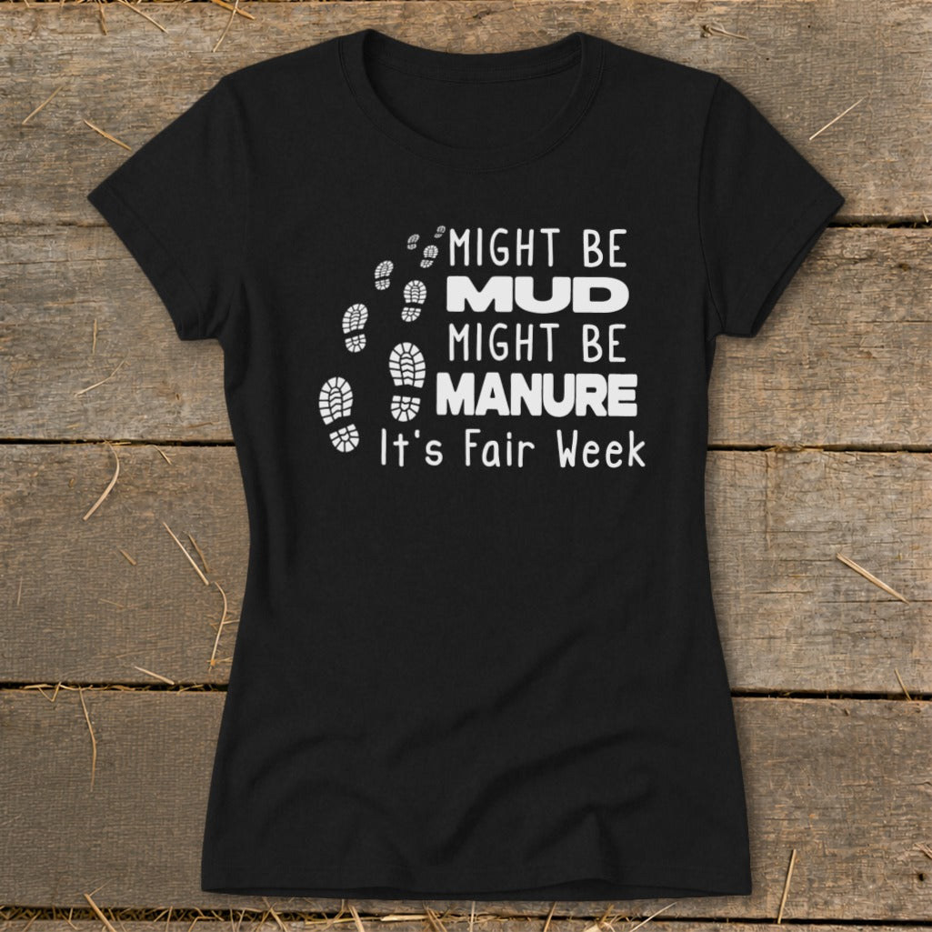Black t-shirt with "Might Be Mud, Might Be Manure. It's Fair Week." text and footprints.