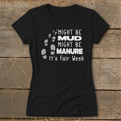 Black t-shirt with "Might Be Mud, Might Be Manure. It's Fair Week." text and footprints.