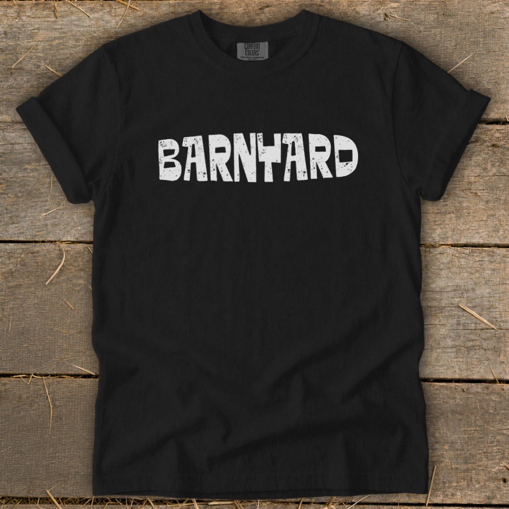 Black t-shirt with rolled sleeves displaying the distressed white text BARNYARD centered on the chest.