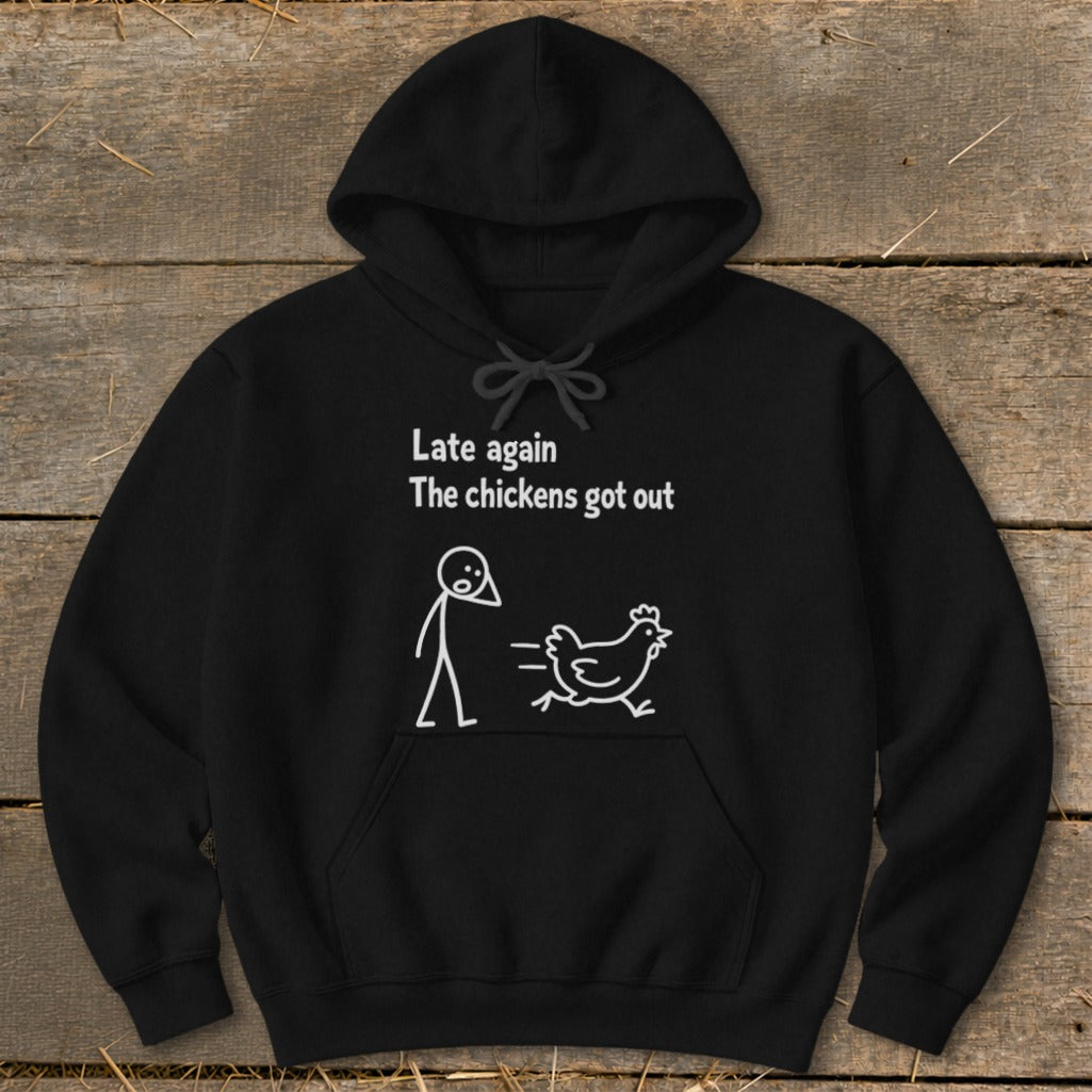 Black hoodie with white text and cartoon of person and chicken: "Late again The chickens got out"