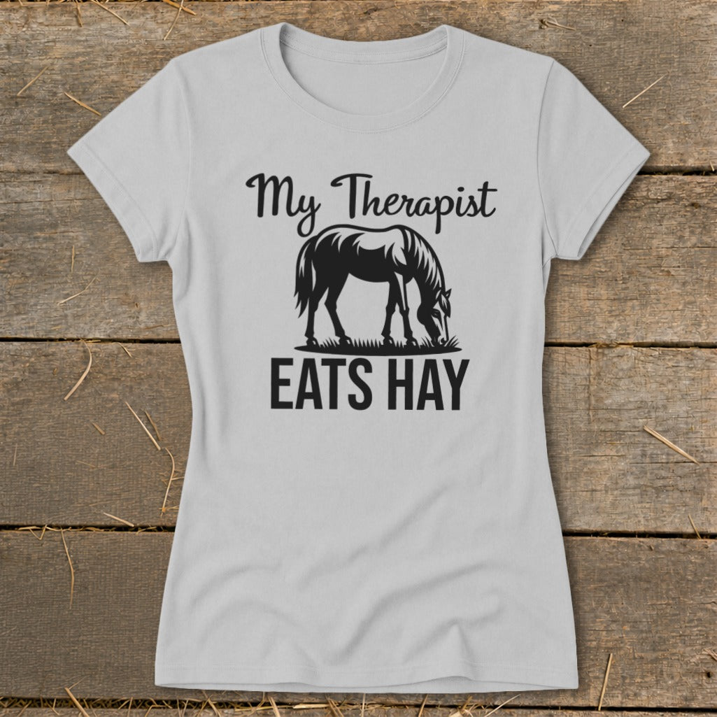 Light gray t-shirt with black text and horse graphic: "My Therapist Eats Hay."