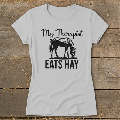 Light gray t-shirt with black text and horse graphic: "My Therapist Eats Hay."