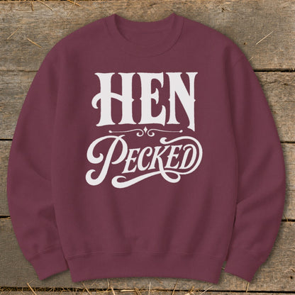 Maroon sweatshirt with white text reading "HEN Pecked" in decorative font.